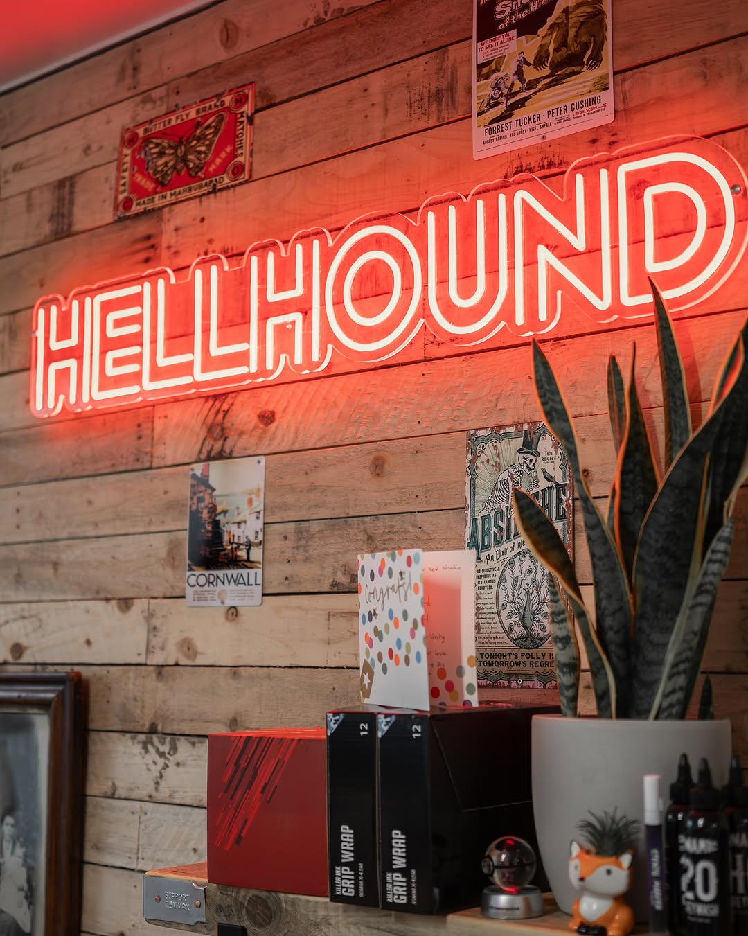 HellHound studio interior, with neon sign and posters on the wall.
